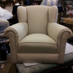 This is an winged armchair fully re-upholstered